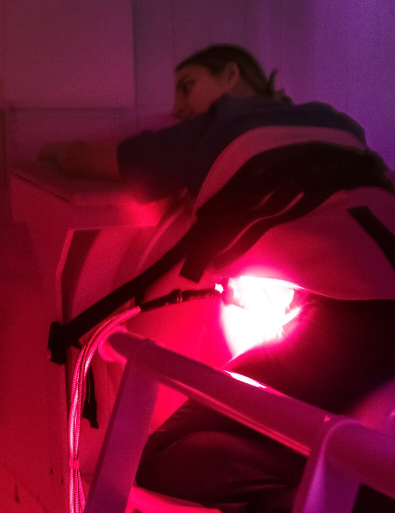 A pregnant woman positioning the fetus into the MEG.